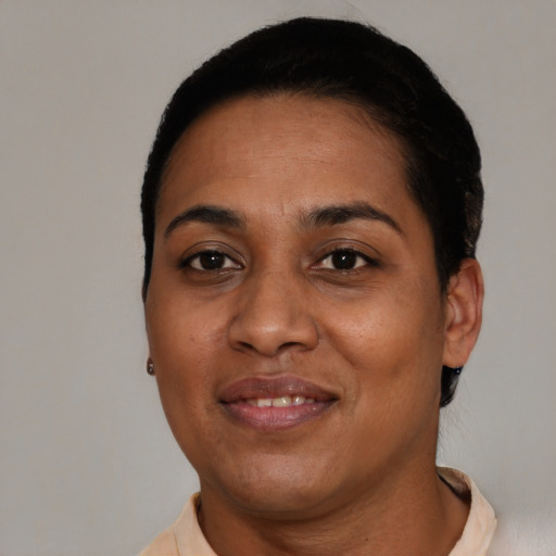 Joyful latino adult female with short  black hair and brown eyes