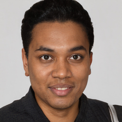 Joyful black young-adult male with short  black hair and brown eyes