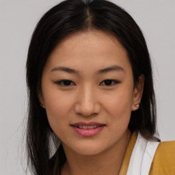 Joyful asian young-adult female with long  brown hair and brown eyes