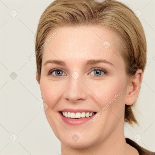 Joyful white young-adult female with short  brown hair and grey eyes