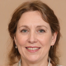 Joyful white adult female with medium  brown hair and grey eyes