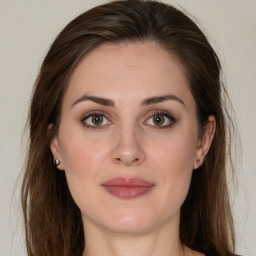 Joyful white young-adult female with long  brown hair and green eyes