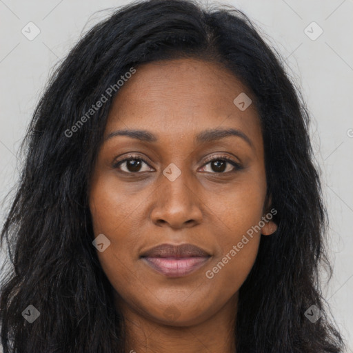 Joyful black young-adult female with long  brown hair and brown eyes