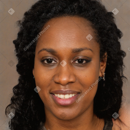 Joyful black young-adult female with long  black hair and brown eyes