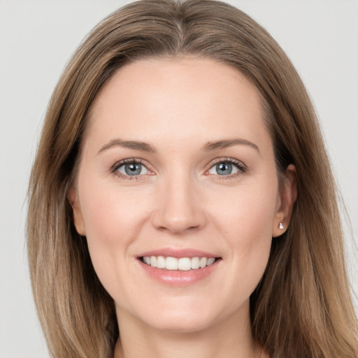 Joyful white young-adult female with long  brown hair and grey eyes