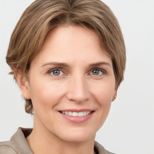 Joyful white adult female with medium  brown hair and grey eyes