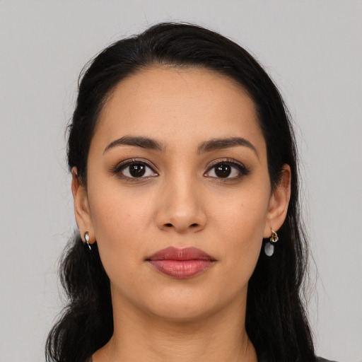 Joyful latino young-adult female with long  black hair and brown eyes