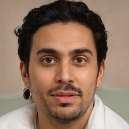 Joyful latino young-adult male with short  brown hair and brown eyes