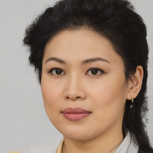 Joyful asian young-adult female with long  brown hair and brown eyes