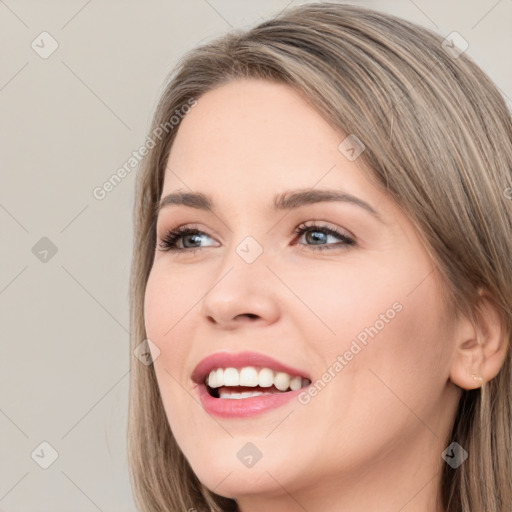 Joyful white young-adult female with long  brown hair and grey eyes