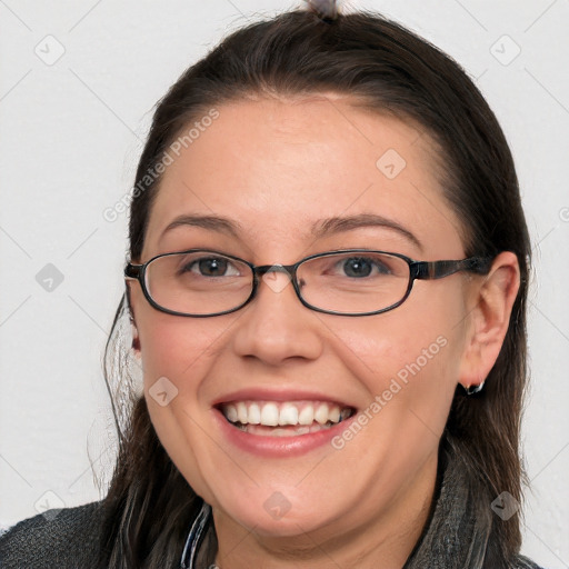 Joyful white young-adult female with long  brown hair and blue eyes