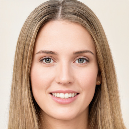 Joyful white young-adult female with long  brown hair and green eyes