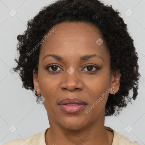 Joyful black adult female with short  brown hair and brown eyes