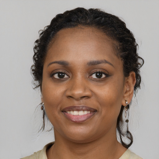Joyful black young-adult female with medium  brown hair and brown eyes