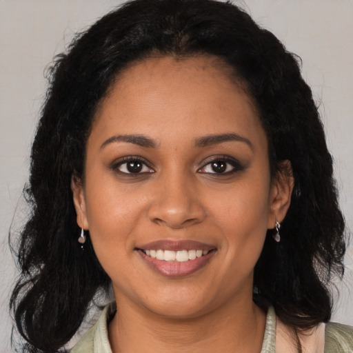 Joyful black young-adult female with medium  brown hair and brown eyes