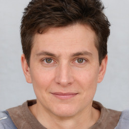 Joyful white adult male with short  brown hair and grey eyes