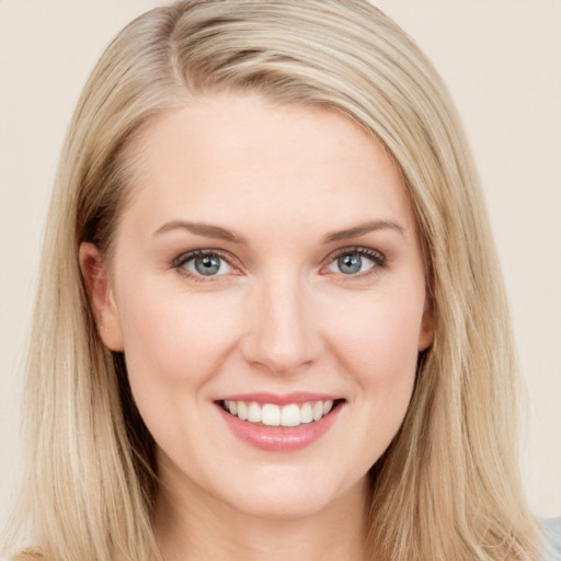 Joyful white young-adult female with long  brown hair and blue eyes