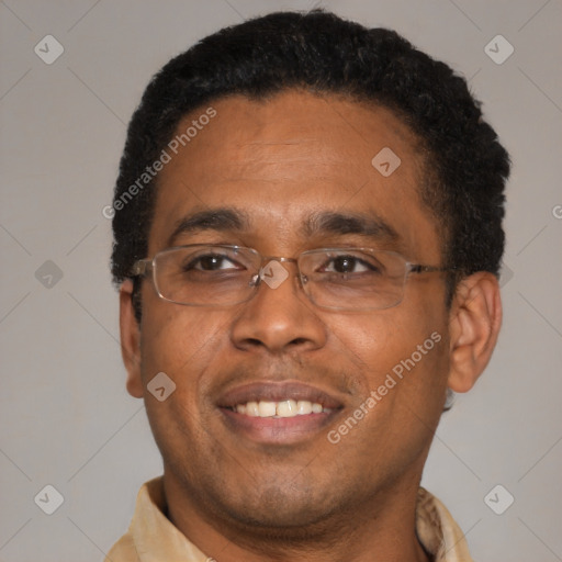 Joyful latino adult male with short  brown hair and brown eyes