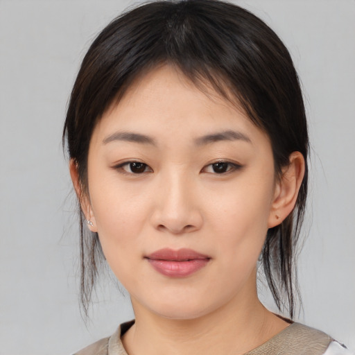 Joyful asian young-adult female with medium  brown hair and brown eyes