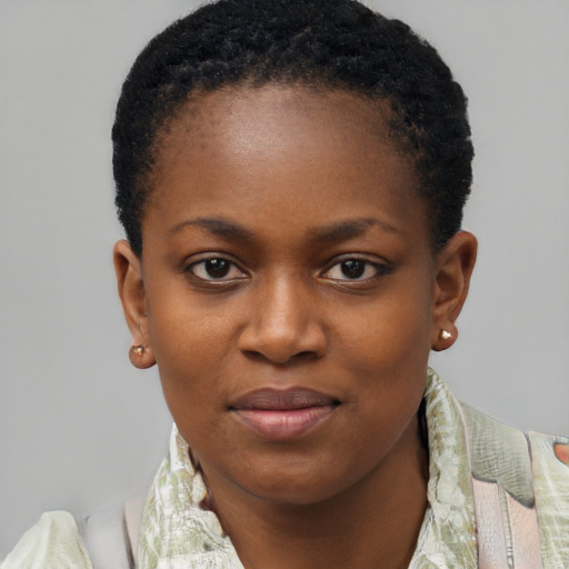 Joyful black young-adult female with short  black hair and brown eyes