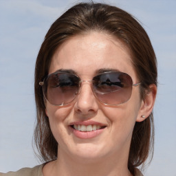 Joyful white adult female with medium  brown hair and brown eyes