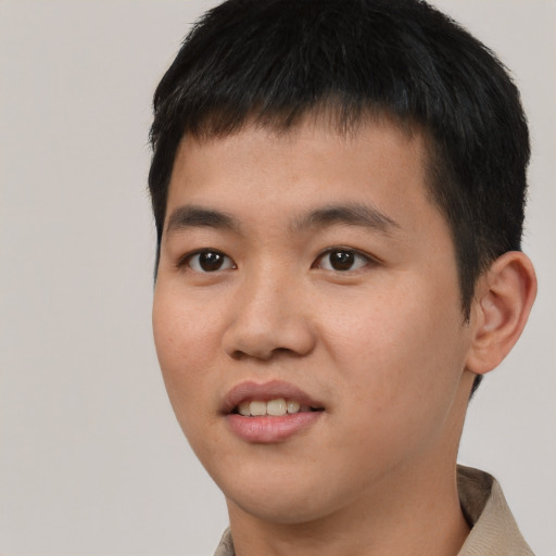 Joyful asian young-adult male with short  black hair and brown eyes