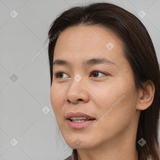 Joyful asian young-adult female with medium  brown hair and brown eyes