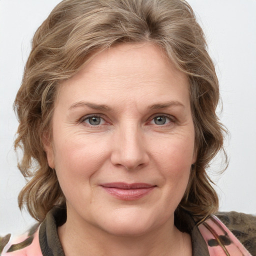 Joyful white adult female with medium  brown hair and grey eyes