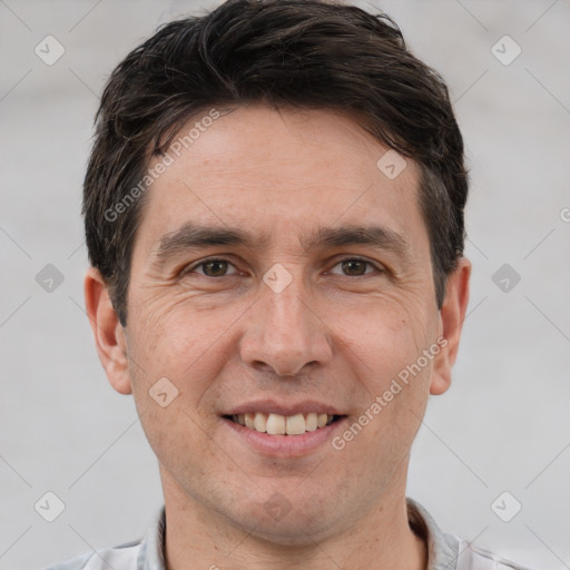 Joyful white adult male with short  brown hair and brown eyes