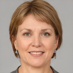 Joyful white adult female with medium  brown hair and grey eyes