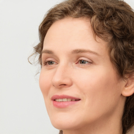 Joyful white young-adult female with medium  brown hair and green eyes