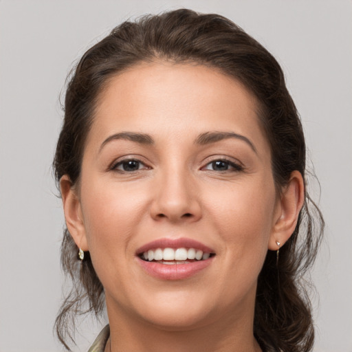 Joyful white young-adult female with medium  brown hair and brown eyes