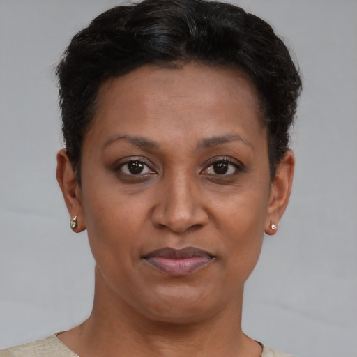 Joyful black adult female with short  brown hair and brown eyes
