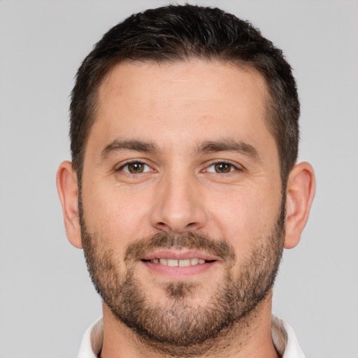 Joyful white young-adult male with short  brown hair and brown eyes