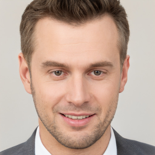 Joyful white young-adult male with short  brown hair and brown eyes