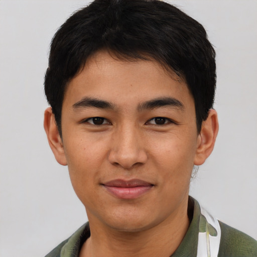 Joyful asian young-adult male with short  brown hair and brown eyes