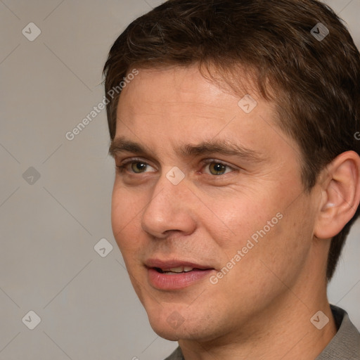 Joyful white adult male with short  brown hair and grey eyes