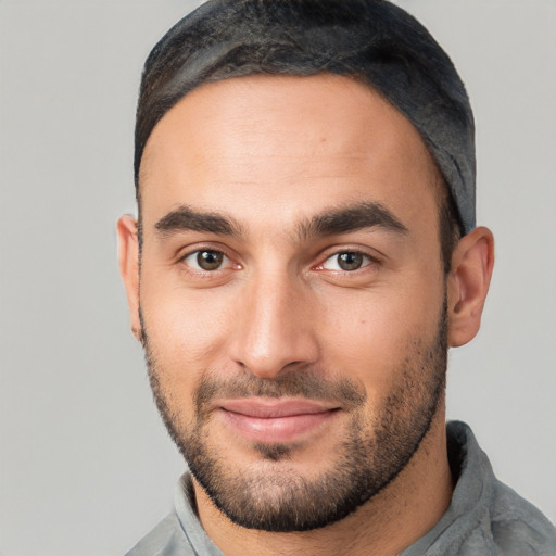 Joyful white young-adult male with short  black hair and brown eyes