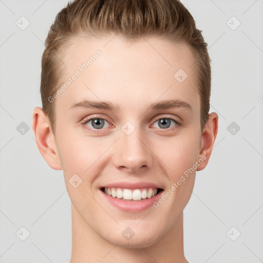 Joyful white young-adult male with short  brown hair and grey eyes