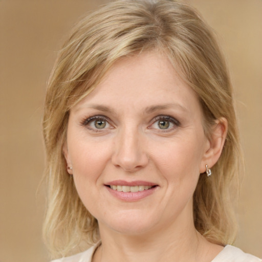 Joyful white adult female with medium  brown hair and green eyes