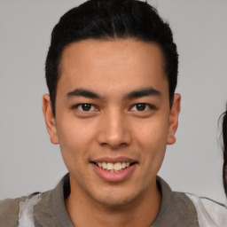 Joyful latino young-adult male with short  brown hair and brown eyes