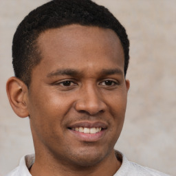 Joyful latino young-adult male with short  brown hair and brown eyes