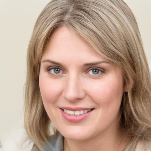 Joyful white young-adult female with medium  brown hair and blue eyes