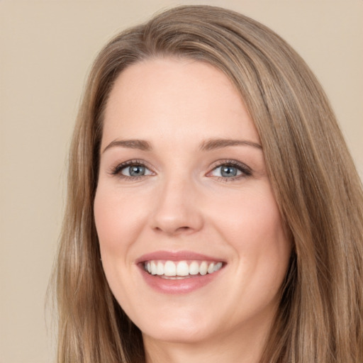 Joyful white young-adult female with long  brown hair and green eyes