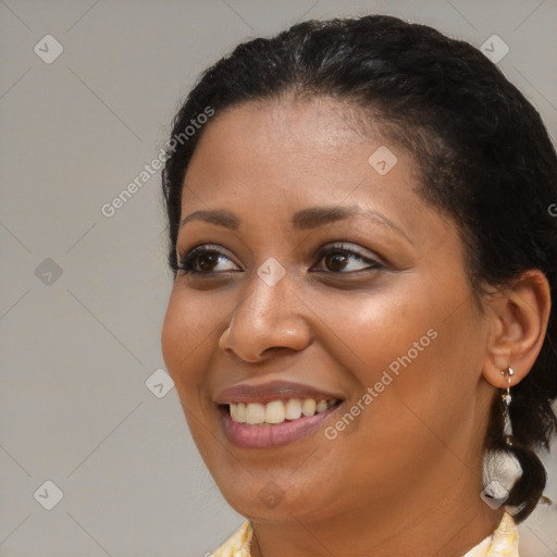 Joyful black young-adult female with medium  brown hair and brown eyes