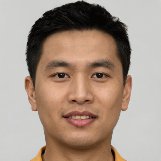 Joyful asian young-adult male with short  black hair and brown eyes