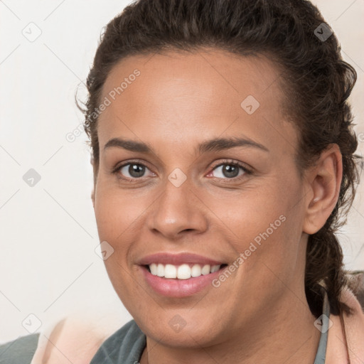 Joyful white young-adult female with long  brown hair and brown eyes