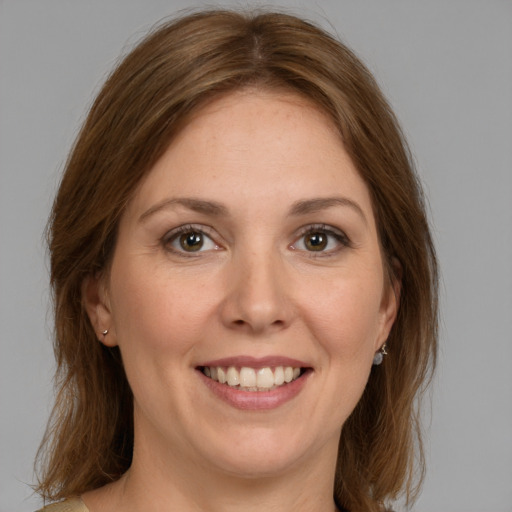 Joyful white young-adult female with medium  brown hair and grey eyes