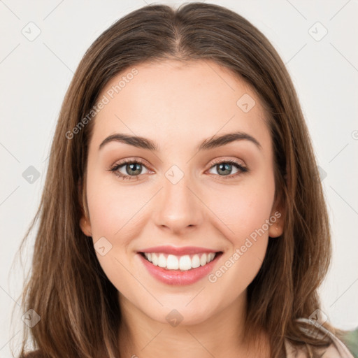 Joyful white young-adult female with long  brown hair and green eyes