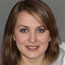 Joyful white young-adult female with medium  brown hair and grey eyes